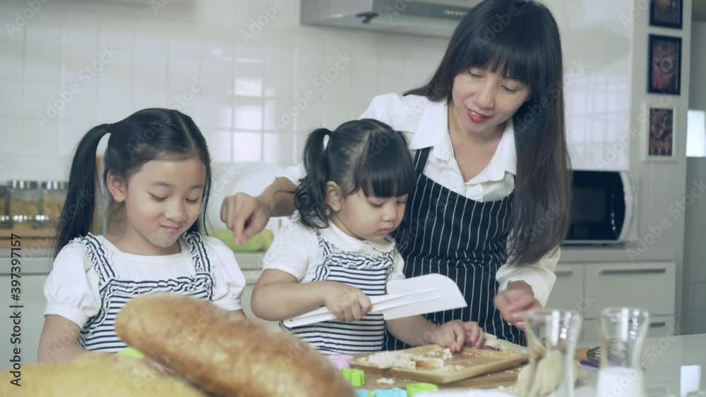 Childhood daughter and mother cooking in kitchen Childhood daughter and mother cooking in kitchen