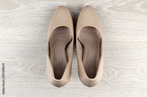 Beige women's shoes on a light background. Women's shoes with heels