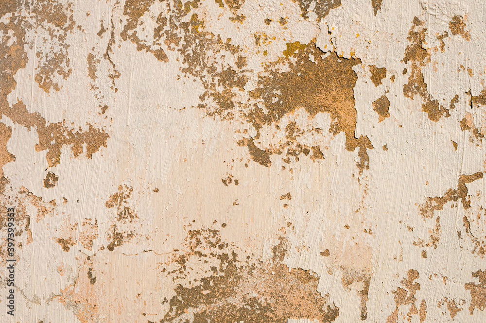 Grunge background of cracked peeling walls with peeled putty in beige tones Grunge background of cracked peeling walls with peeled putty in beige tones
