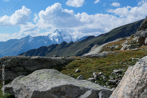 Panoramic view from Hohe Sonnblick in Austrian Alps on Gro?glockner. The whole area is very steep and dangerous, with many lose stones. Green, steep meadows in front. Sunny day. Expedition