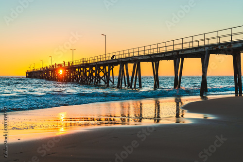 People fishing from Port Noarlunga jetty at sunset