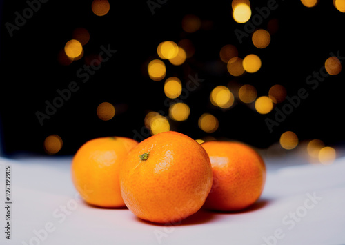 tangerine in the snow, bokeh on the background