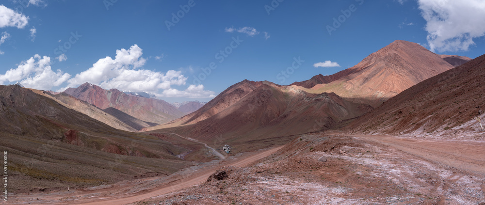 Panorama view of high-altitude Pamir highway in no-man's land between borders of Kyrgyzstan and Tajikistan at Kyzyl Art pass in Trans Alay mountain range