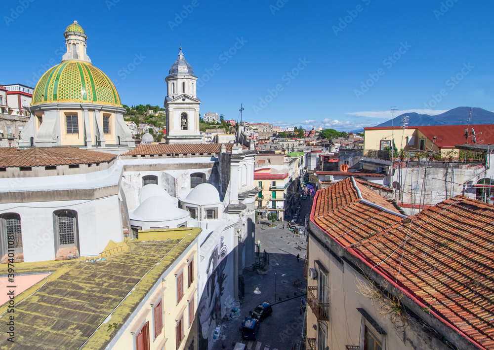 Naples, Italy - located over the Catacombs of San Gaudioso, the Church of Santa Maria della Sanità  is very recognizable for its green dome and Mount Vesuvius on the background
