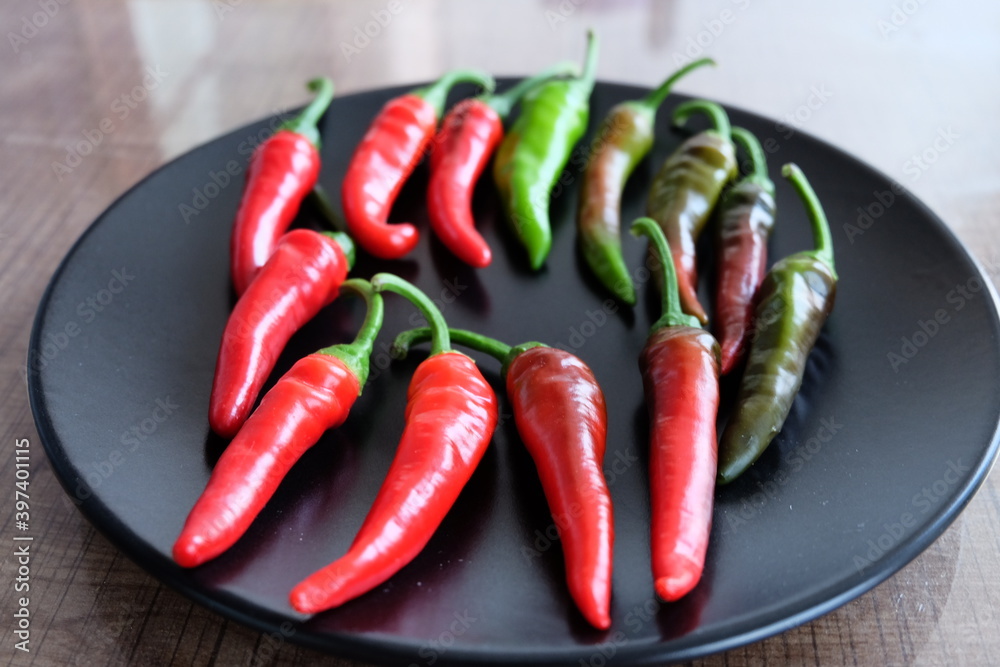 Life cycle of peppers. Stages of red hot pepper growth from green to red. Hot ripen chili peppers without GMO. Nature. Organic Mexican or Turkish spices. It is called 
