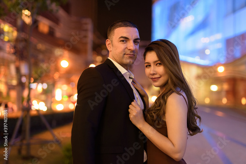 Portrait of couple outdoors at night in the city at Bangkok Thailand © Ranta Images