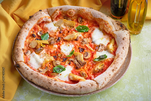 Pizza carciofo. Vegetarian pizza with Mozzarella, artichokes, mushrooms, basil.