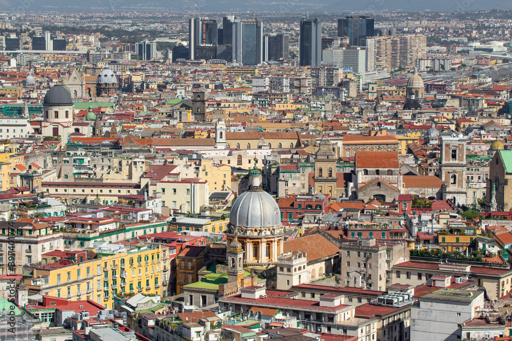 Fototapeta premium Naples, Italy - a Unesco World Heritage old town, Naples displays also a modern business center, here dominated by Mount Vesuvius on the background 