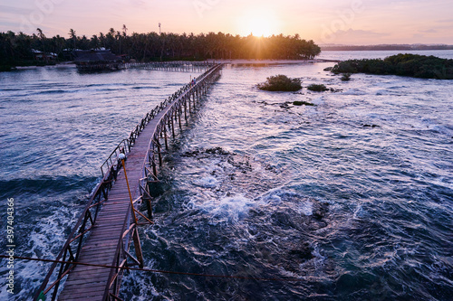 Beautiful landscape. Sunset on the seashore. Wooden bridge on Cloud 9 beach  Siargao Island Philippines.