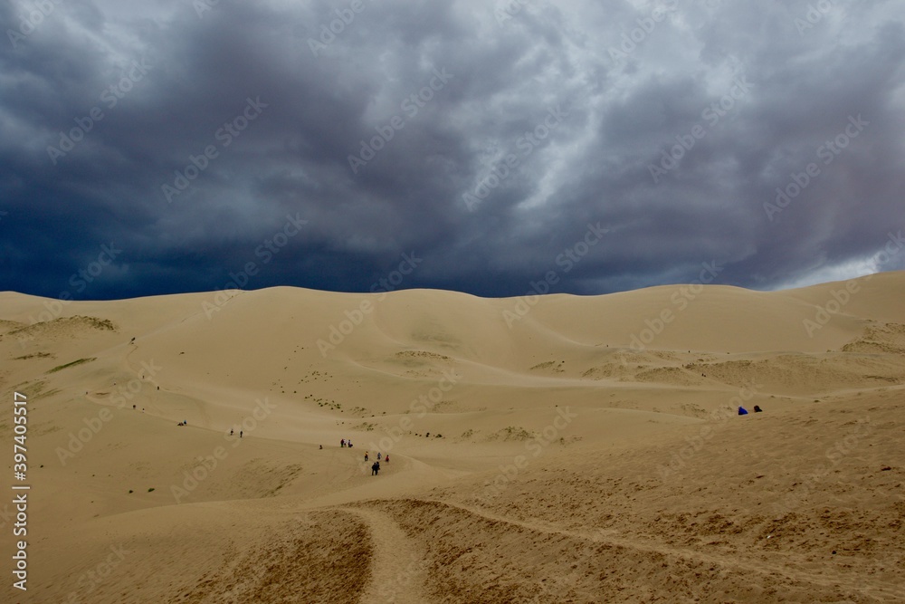 Dramatic sky over Gobi desert sand dunes, Mongolia 