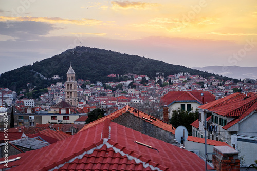 Beautiful sunset cityscape with red tiled roofs of Split old town, Croatia.