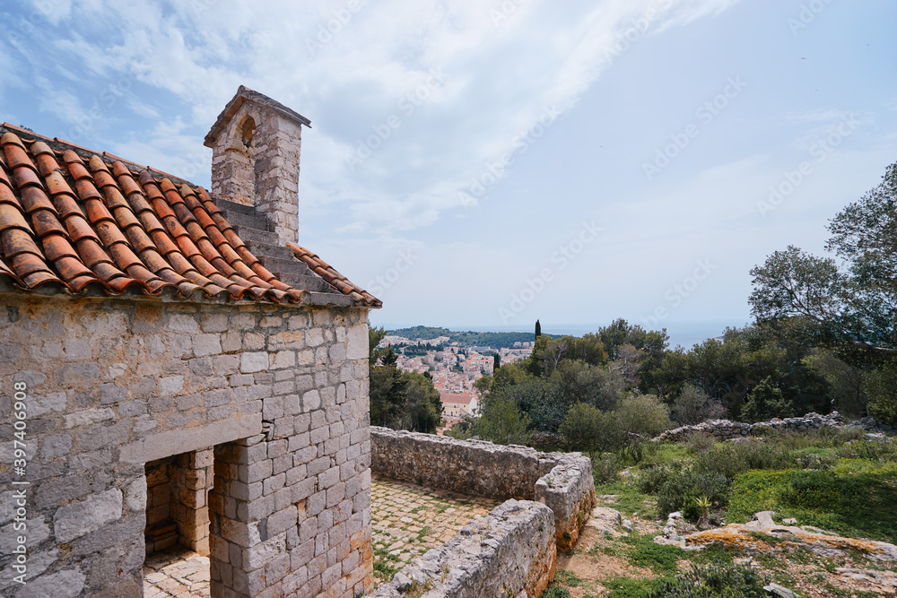 Ancient small catholic chapel made from stones with tiled roof.