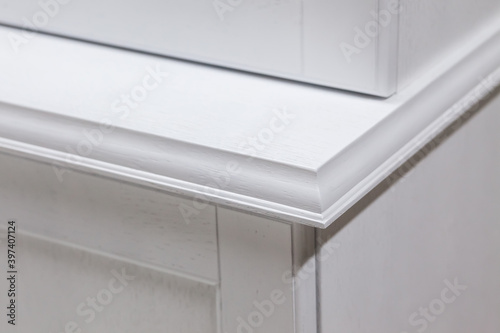 Close-up corner of white modern kitchen cabinet table top.