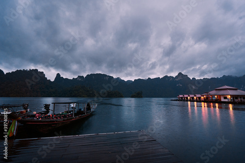 Traditional wooden boats on wharf in Cheow Lan Lake, Khao sok national park at night time, Thailand.