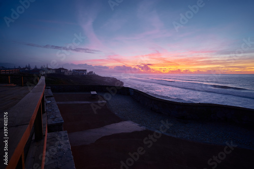 Beautiful landscape with colorful sunset on the Atlantic ocean rock shore, Portugal. © luengo_ua