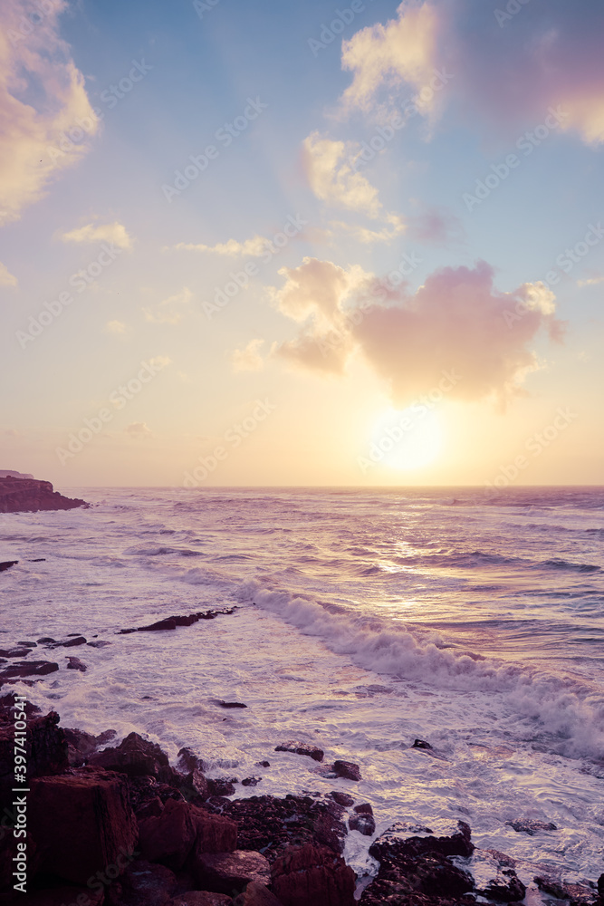 Obraz premium Amazing sunset on Atlantic ocean. Waves and foam.