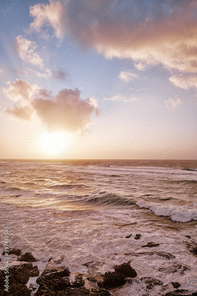 Amazing sunset on Atlantic ocean. Waves and foam.