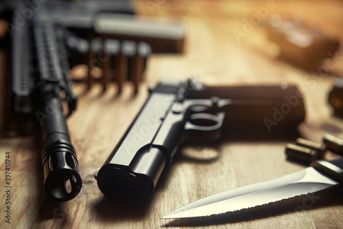 Weapons and military equipment for army, Assault rifle gun, handgun and knife on wooden background.