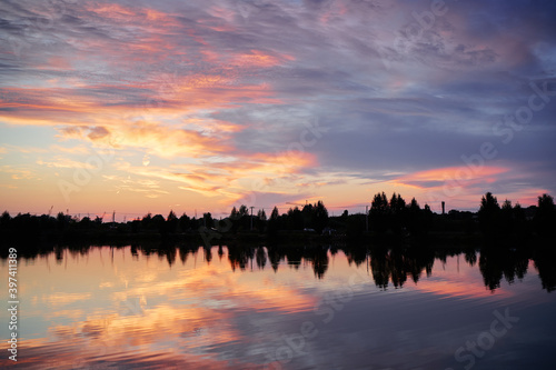 Fototapeta Naklejka Na Ścianę i Meble -  Lake in beautiful sunset time with wonderful sky reflecting in water.