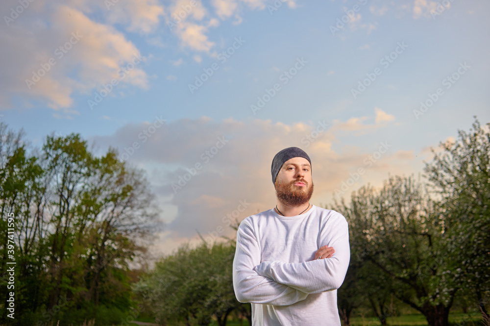 Outdoor portrait of confident bearded young man.