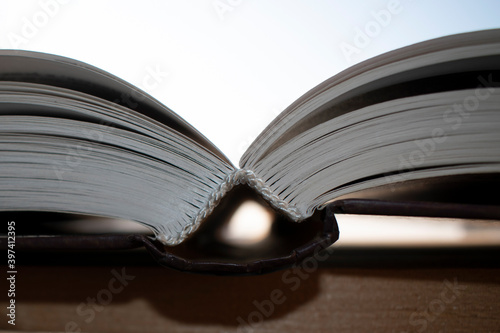 Принти на полотні One open book on the windowsill. Light background.