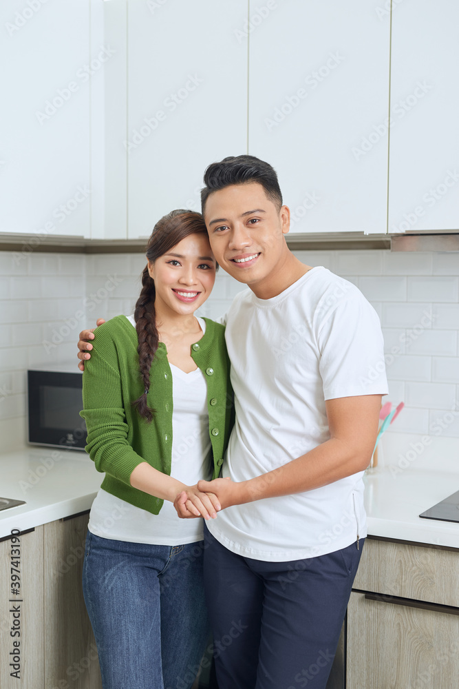 Romantic young couple cooking together in the kitchen,having a great time together. Romantic young couple cooking together in the kitchen,having a great time together.