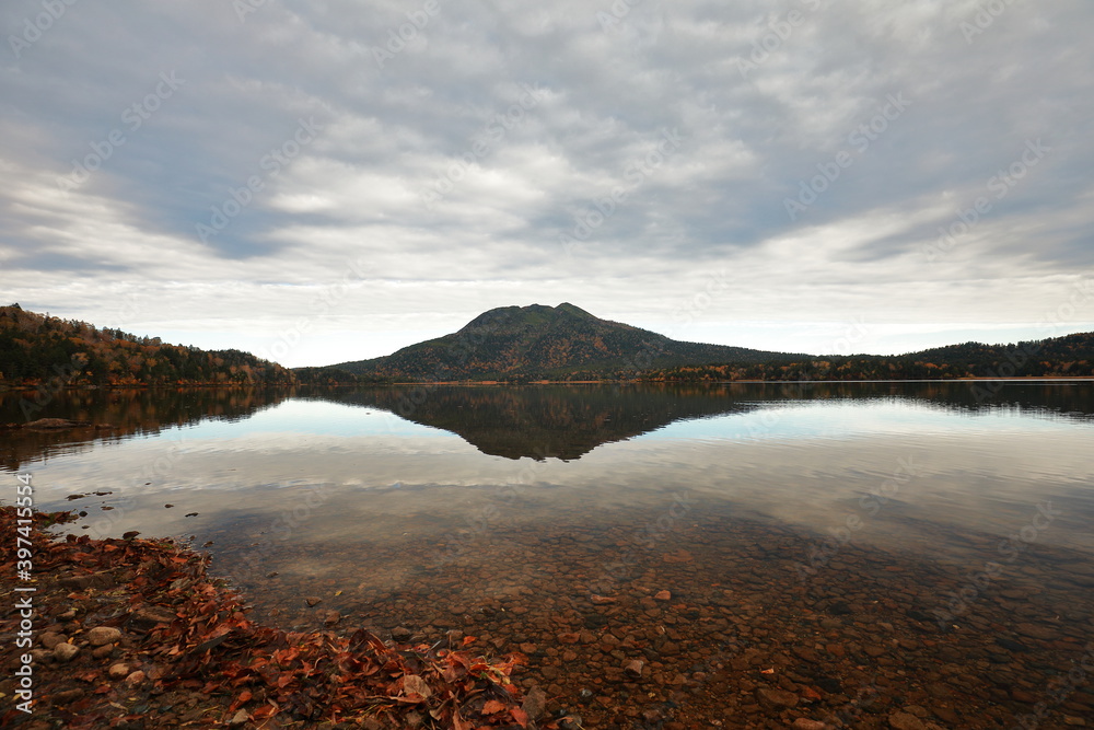 Reflection of Hiuchigatake mountain in the water in Oze marsh, Japan