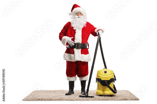 Full length portrait of santa claus with a vacuum cleaner