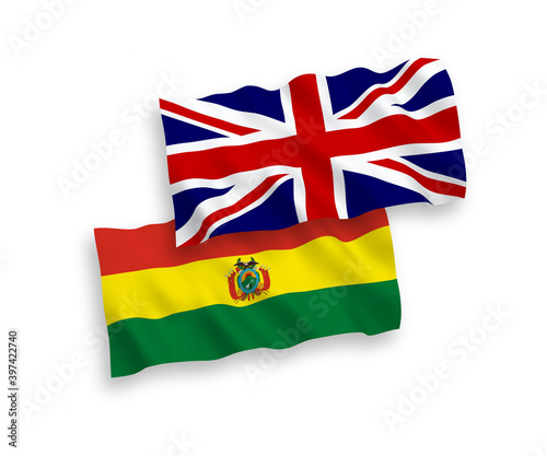 National vector fabric wave flags of Great Britain and Bolivia isolated on white background. 1 to 2 proportion.