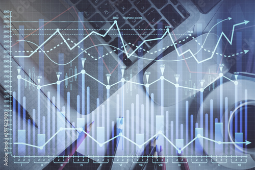 Double exposure of financial chart drawing over table background with computer. Concept of research and analysis. Top view.