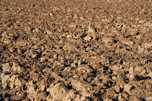 Close up of plowed earth, the nutritious soil is used to grow field crops and food. Pattern.