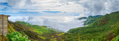 Panoramic view of a mountain surrounded by clouds