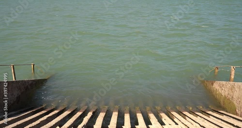 water moving in the Beninar reservoir, there is an abandoned metal sieve photo