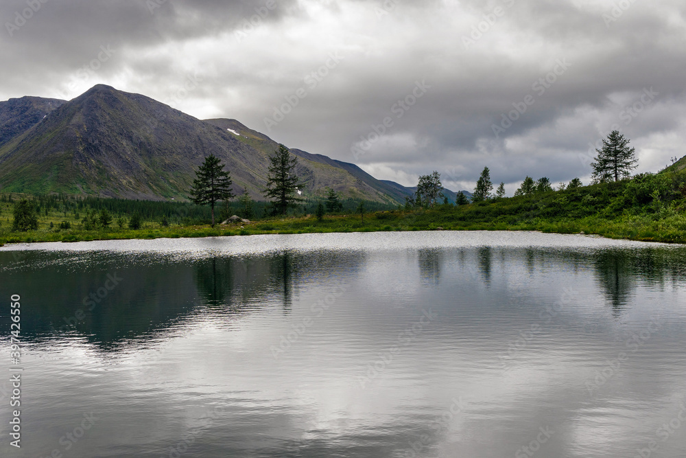 cold lake in the mountains on a cloudy summer day