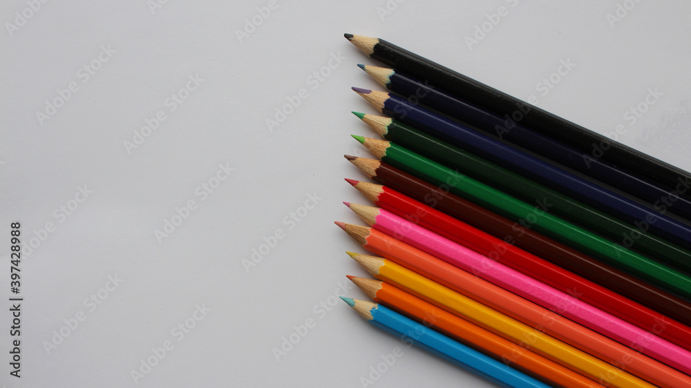 Naklejka premium Wooden colored pencils isolated on white background. Creation. Place for text.