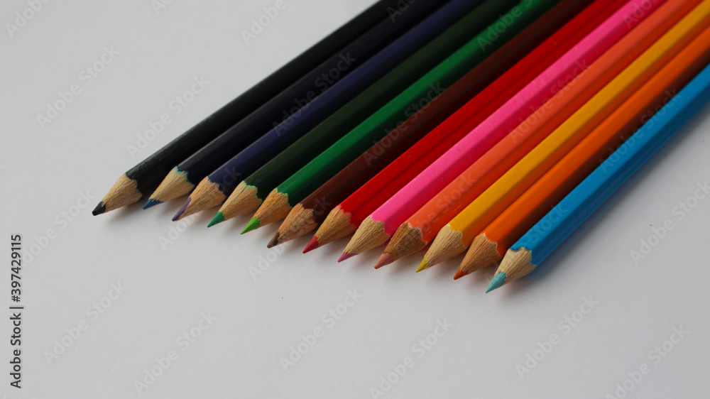 Wooden colored pencils isolated on white background. Creation. Place for text. Wooden colored pencils isolated on white background. Creation. Place for text.