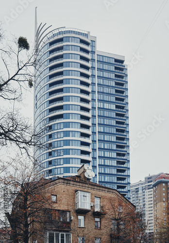 An old brick house and a new skyscraper on its background. Kyiv, Ukraine. © Vitaly