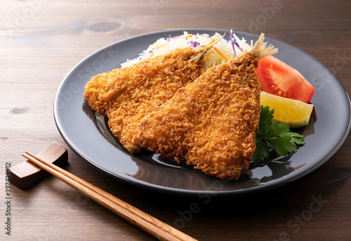 Fried horse mackerel served on a plate on a wooden background