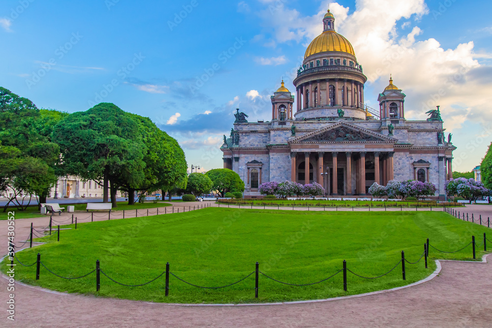 Saint Petersburg. Russia. St. Isaac's Cathedral on the background of trees and lawn. Architecture of the Northern capital. Summer in St. Petersburg. Cathedral on St. Isaac's square. Cities of Russia.