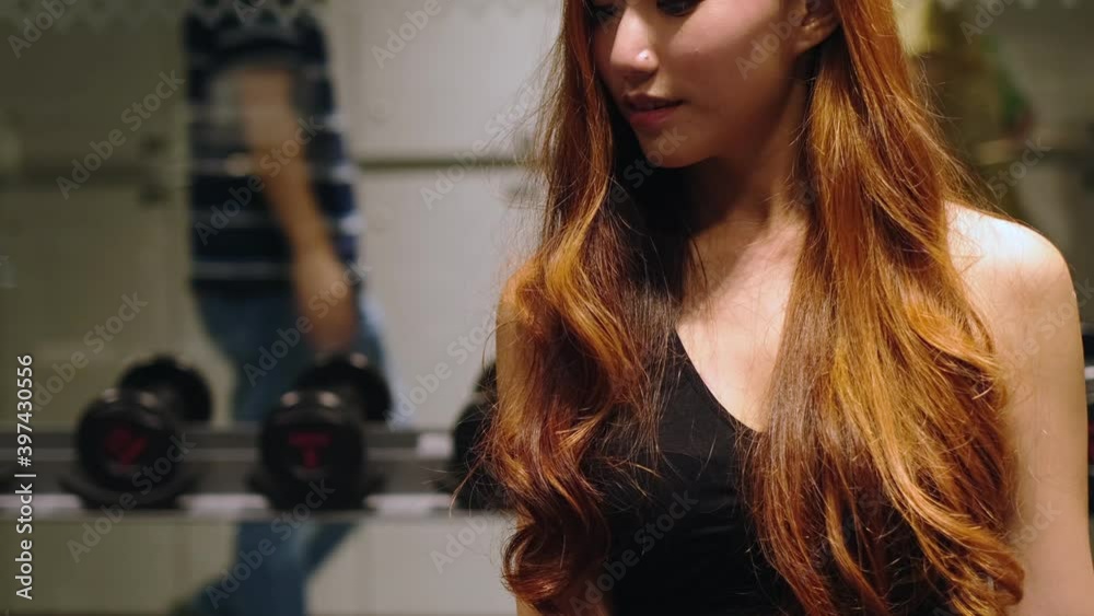 Muscular asian young woman with beautiful body doing exercises . Sporty girl lifting weights in gym. Muscular asian young woman with beautiful body doing exercises . Sporty girl lifting weights in gym.