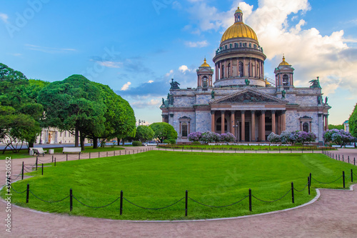 Saint Petersburg. Russia. St. Isaac's Cathedral on the background of trees and lawn. Architecture of the Northern capital. Summer in St. Petersburg. Cathedral on St. Isaac's square. Cities of Russia. © Grispb