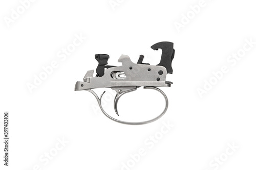 Shock trigger for shotgun isolate on white back. Gun trigger. Repair spare part.