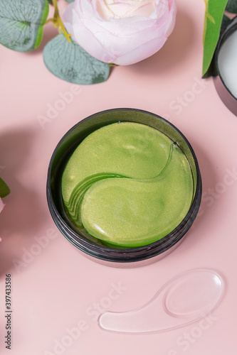 green tea eye patches to reduce puffiness and bruising under the eyes. flatlay. the view from the top on a pink background. the concept of self-care