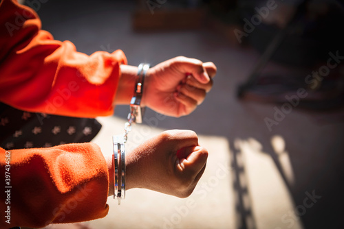 Hands of prisoner in handcuffs.
