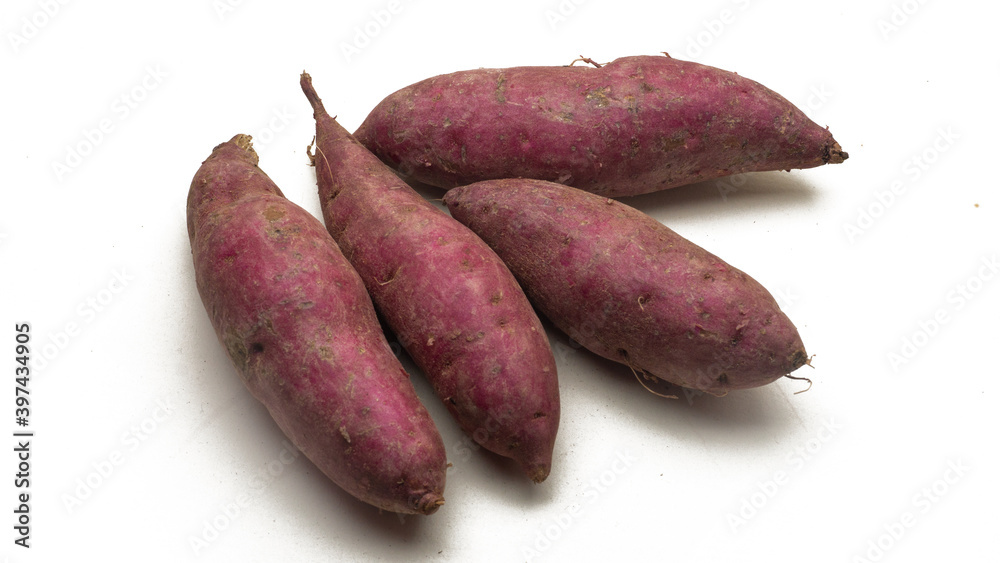 A group of raw sweet potatoes on isolated white background. A group of raw sweet potatoes on isolated white background.