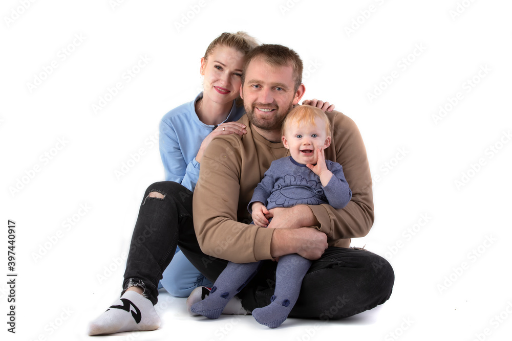 Over white background happy dad mom with one-year-old toddler smiling and looking at the camera.