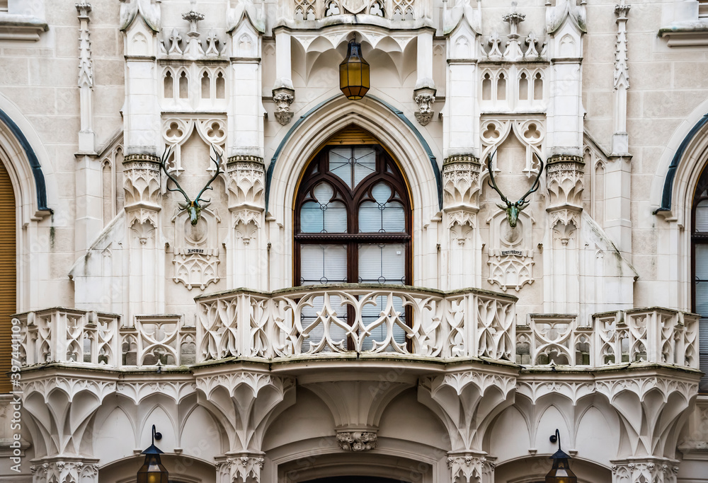 Obraz premium Balcony, carved wall and gothic window of the 13th century Hluboka Castle situated in Hluboko Nad Vltavou, Czech Republic