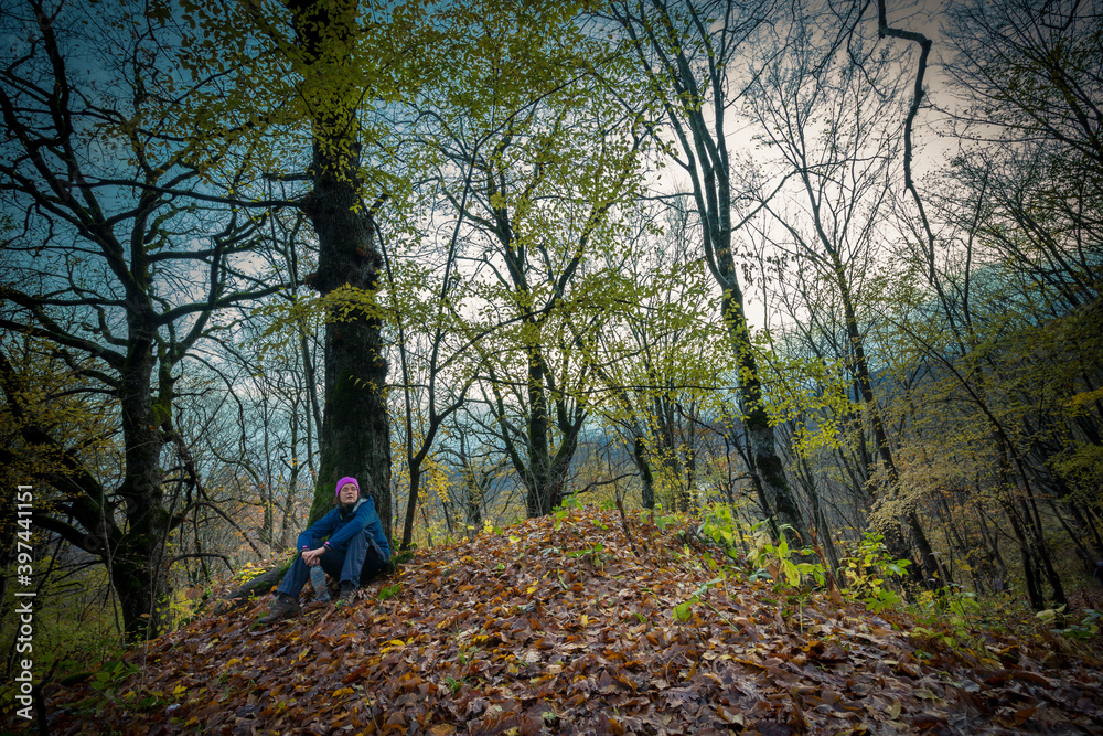 Tourist woman has a rest under the tree