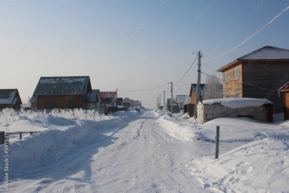 winter in Siberia snow white road in snowdrifts beautiful houses in the village of rime winter in Siberia snow white road in snowdrifts beautiful houses in the village of rime