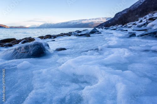 Beautiful winter landscape with icy shore of the fjord